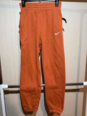 Rust Orange Fleece Joggers with White Swoosh